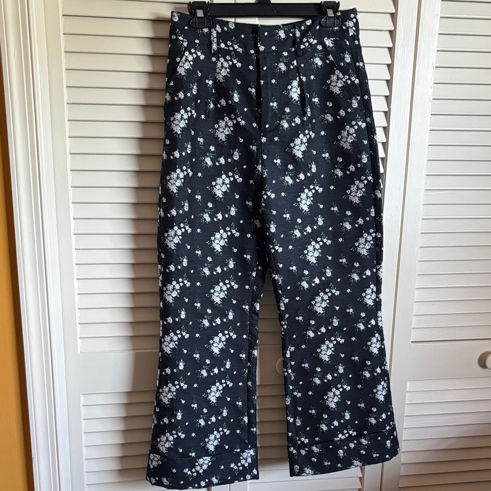Navy boot leg pants with green and white floral pattern